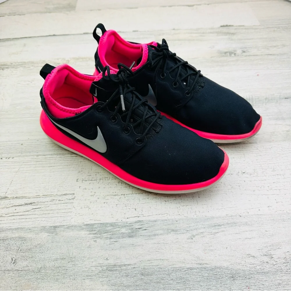 Black and hot pink Nike running shoe